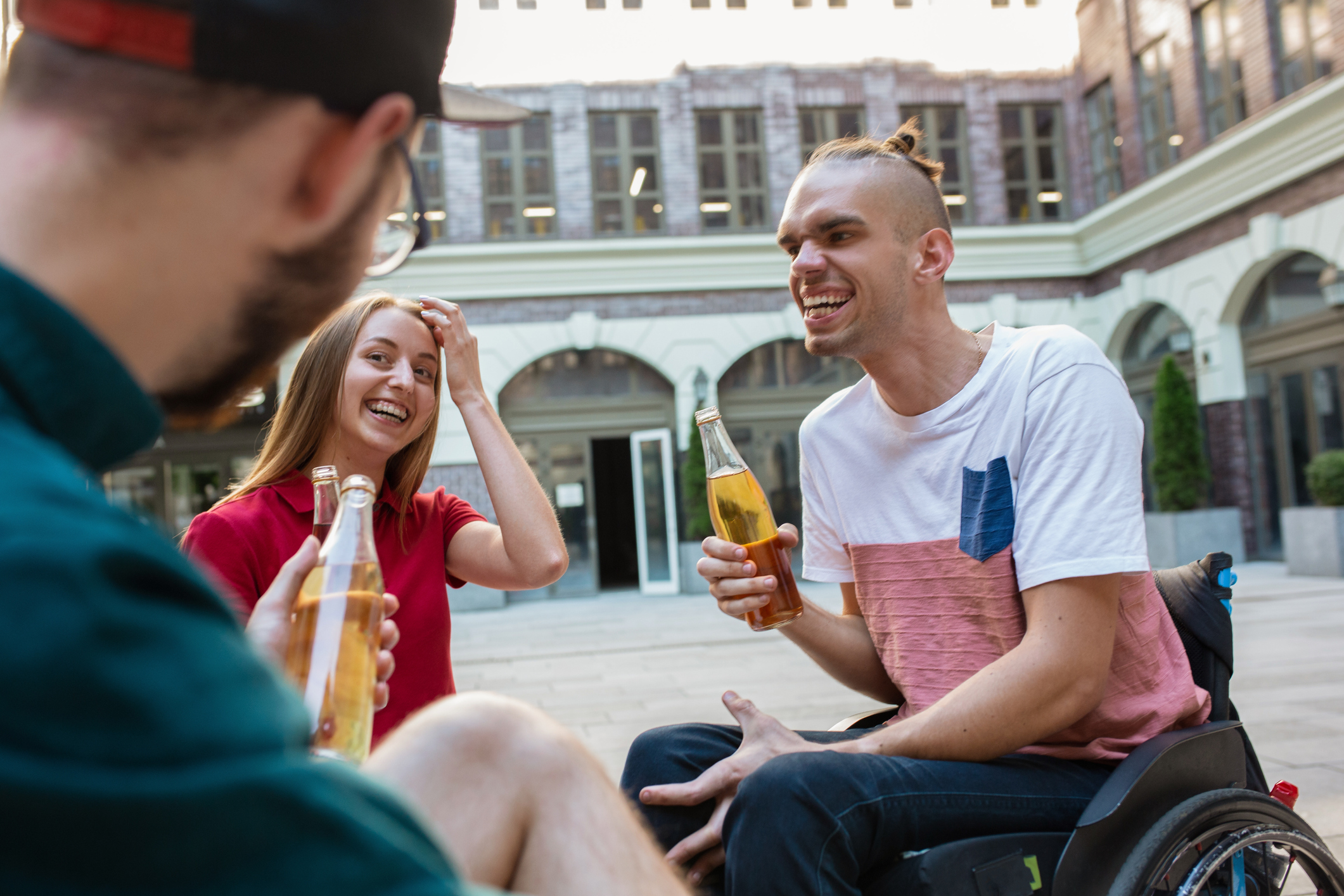 Group of friends taking a stroll on city's street in summer day